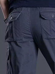 Men's dark gray relaxed fit cargo pants with multiple flap pockets.