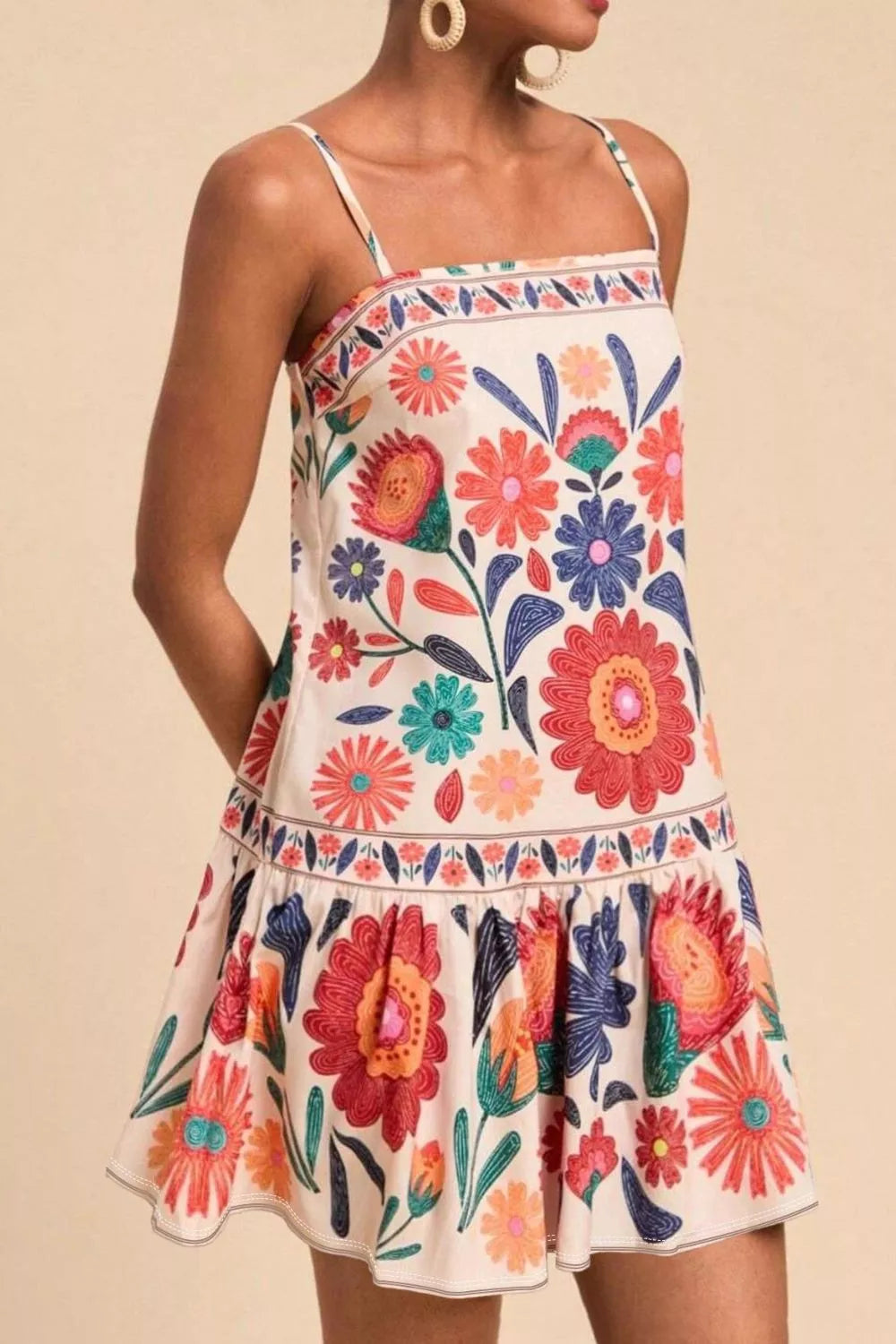 Plus-size mini dress with colorful floral print, square neck, spaghetti straps, and tiered hem.