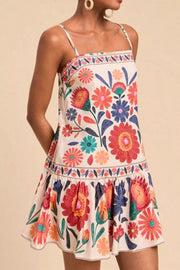 Plus-size mini dress with colorful floral print, square neck, spaghetti straps, and tiered hem.