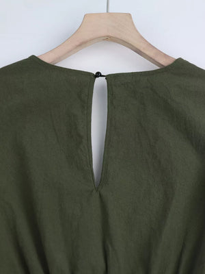 Olive green cotton romper with keyhole back detail and button closure
