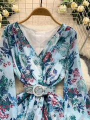 Light blue floral wrap mini dress with V-neck, long sleeves, and white buckle belt.