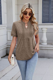 Khaki pleated yoke keyhole tee with short sleeves and a relaxed fit.