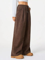 Brown corduroy maternity trousers with wide legs and drawstring waist.