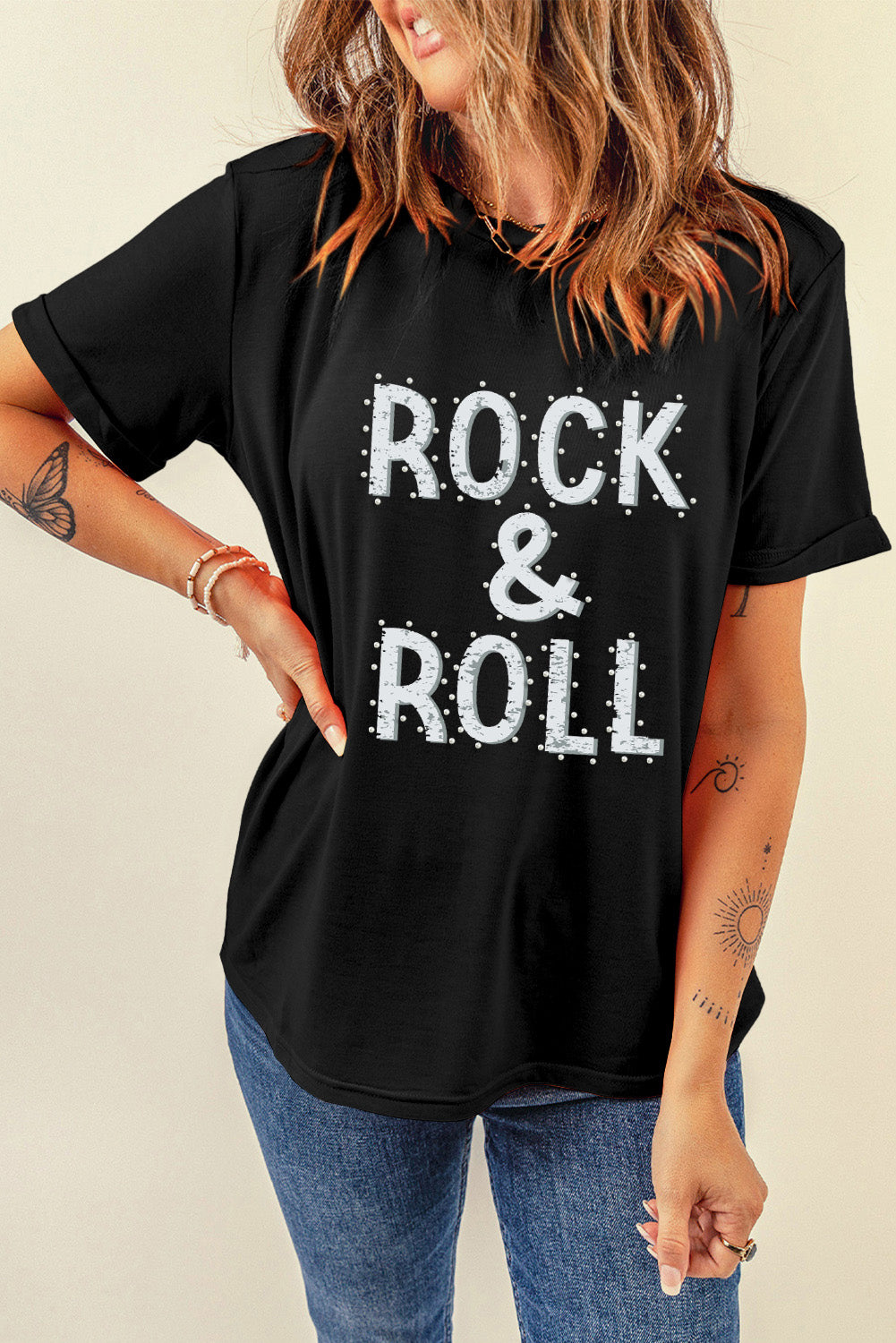 Black graphic t-shirt with white embellished "ROCK & ROLL" text and rolled sleeves.