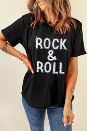 Black graphic t-shirt with white embellished "ROCK & ROLL" text and rolled sleeves.