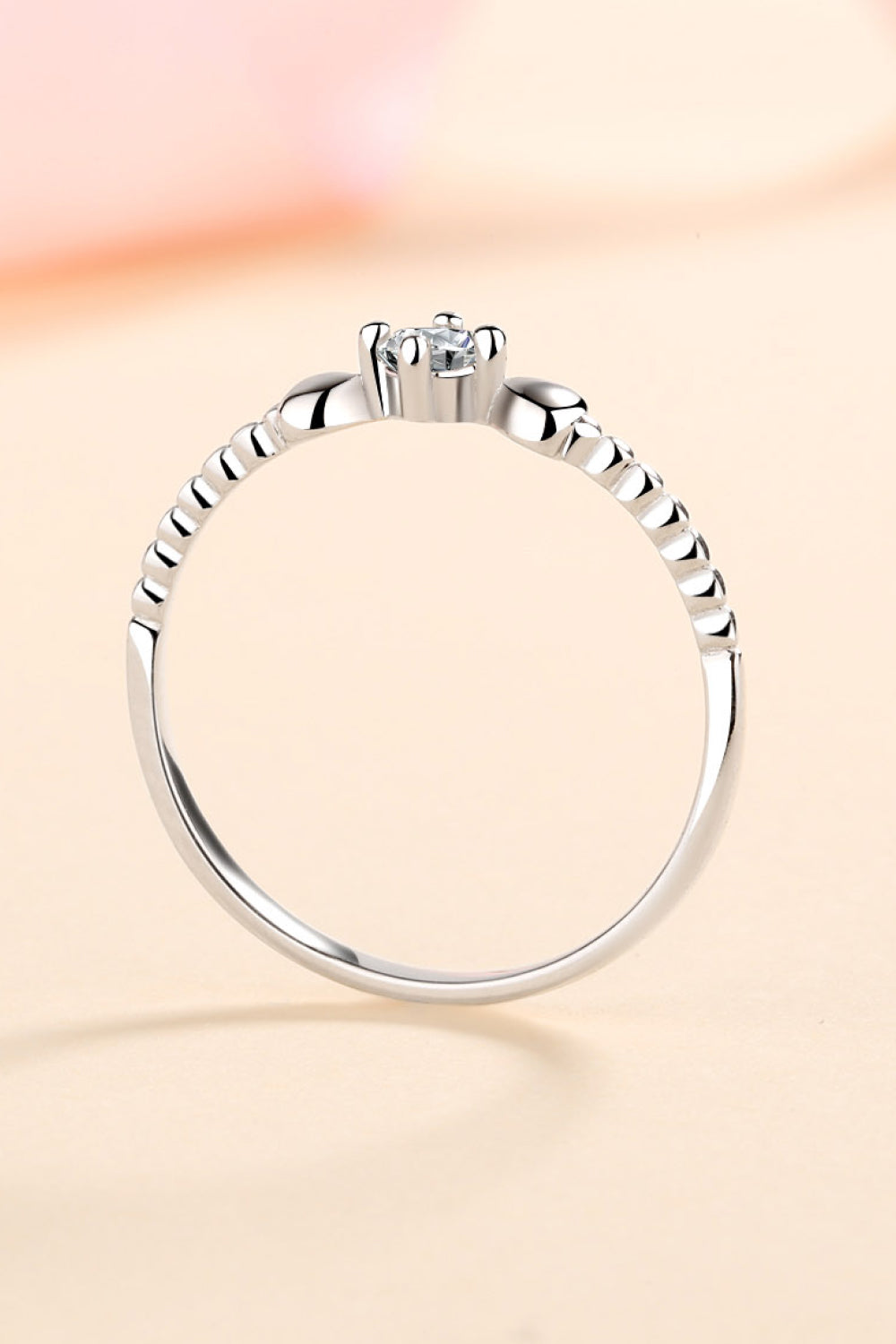 Silver ring with heart motif and moissanite stone