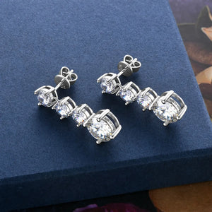 Silver cascade cubic zirconia drop earrings with three stones each.