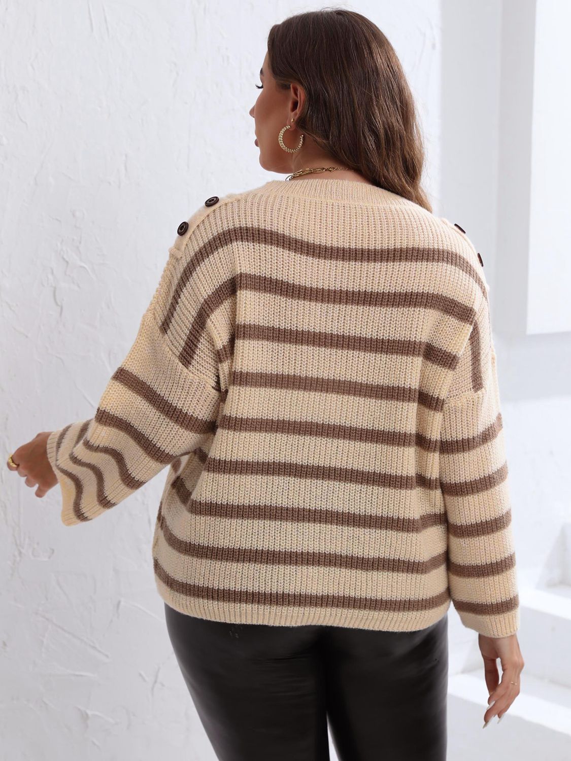 Breton stripe knit sweater in tan with brown stripes and shoulder buttons.