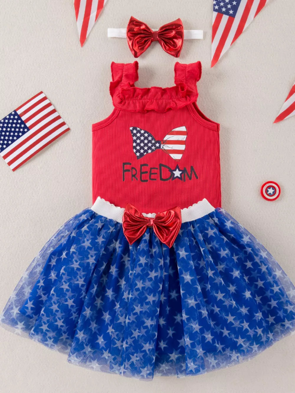 Red tank top with ruffled neckline and bow graphic, paired with a blue star print tulle skirt.