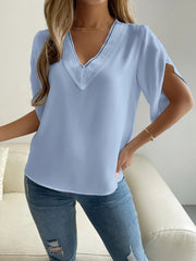 Light blue polyester blouse with V-neck lace trim and cape sleeves