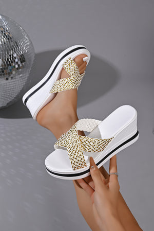 White wedge sandals with woven gold and white straps.