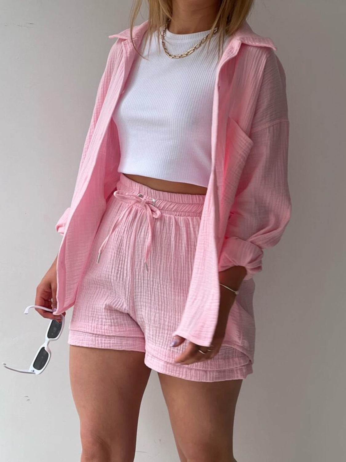 Textured gauze shirt and short co-ord set in blush pink, casual button-up style.