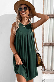 Forest green trapeze dress with V-neck yoke and pleats, sleeveless, casual style