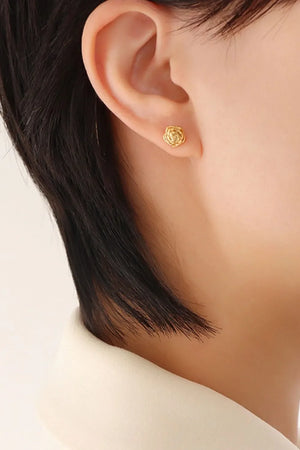 Gold rosebud stud earrings with intricate petal detail.