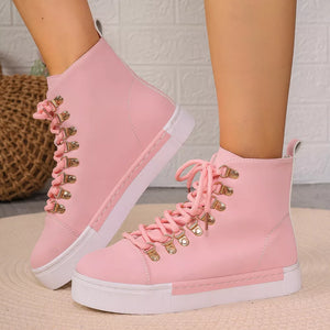 Pink lace-up platform sneakers with gold d-ring eyelets and white soles.