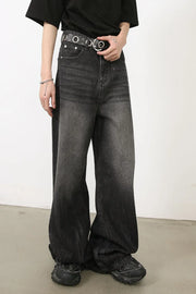 Dark balloon-leg denim jeans with subtle fade and a black grommet belt.