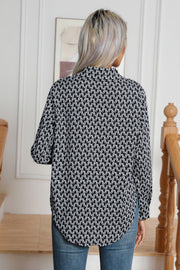Black and white monogram print collared blouse with buttoned cuffs.