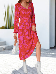 Tiered floral midi dress in hot pink and red with a tie waist and V-neck.