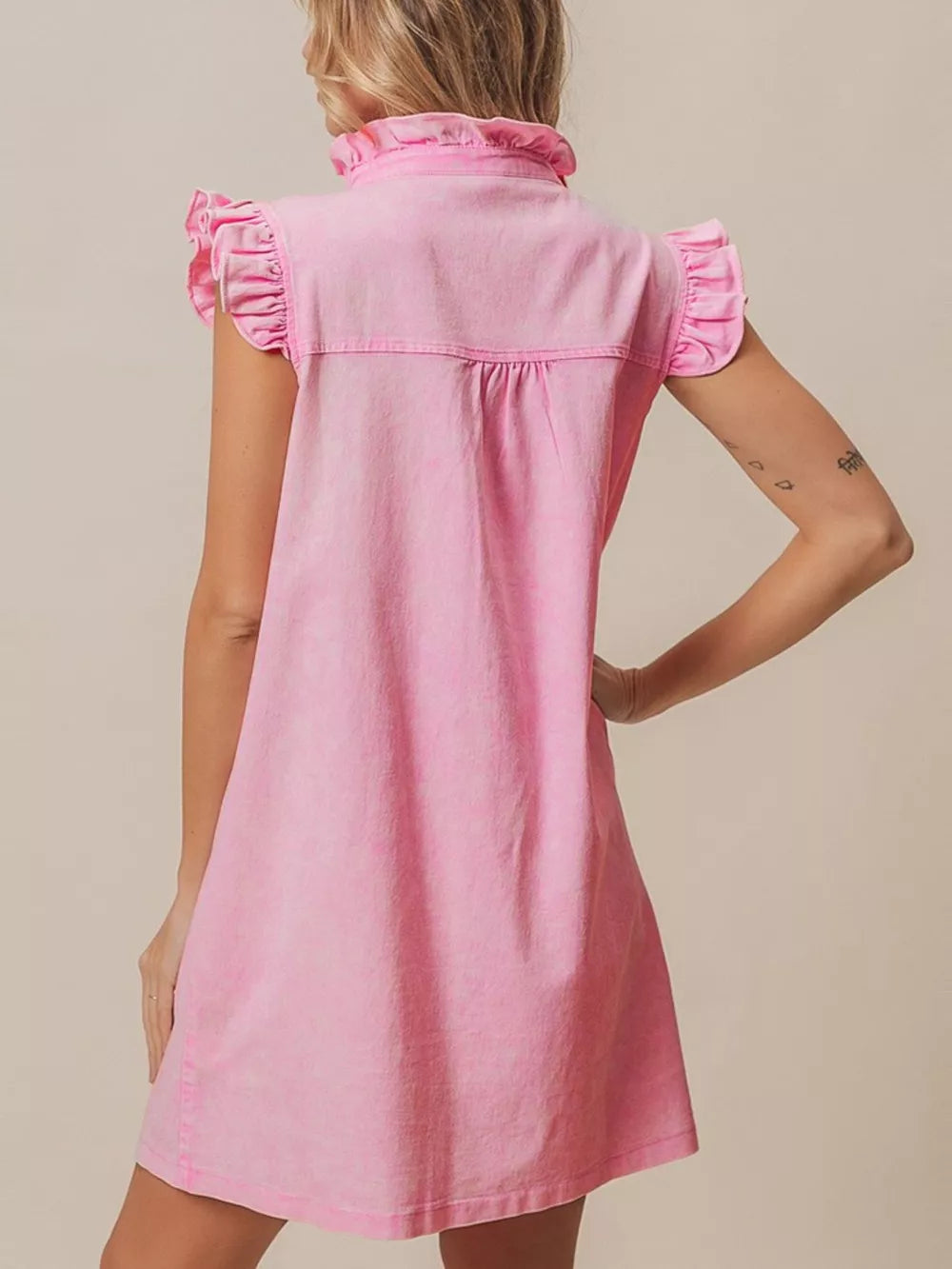 Pink denim dress with ruffled collar and cap sleeves.