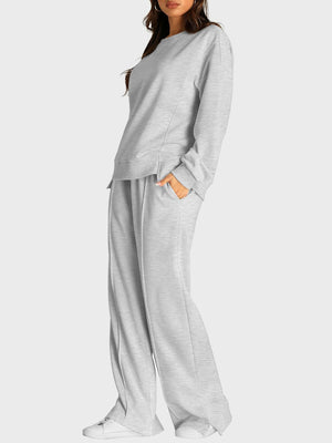 Light gray seamed loungewear set with crewneck sweatshirt and slit-front trousers.