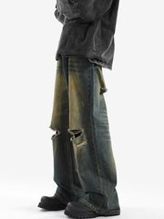 Men's distressed wide-leg jeans in blue denim with ripped details.