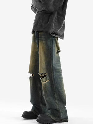 Men's distressed wide-leg jeans in blue denim with ripped details.