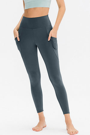 Dark gray performance leggings with ruched pockets and a high waist.