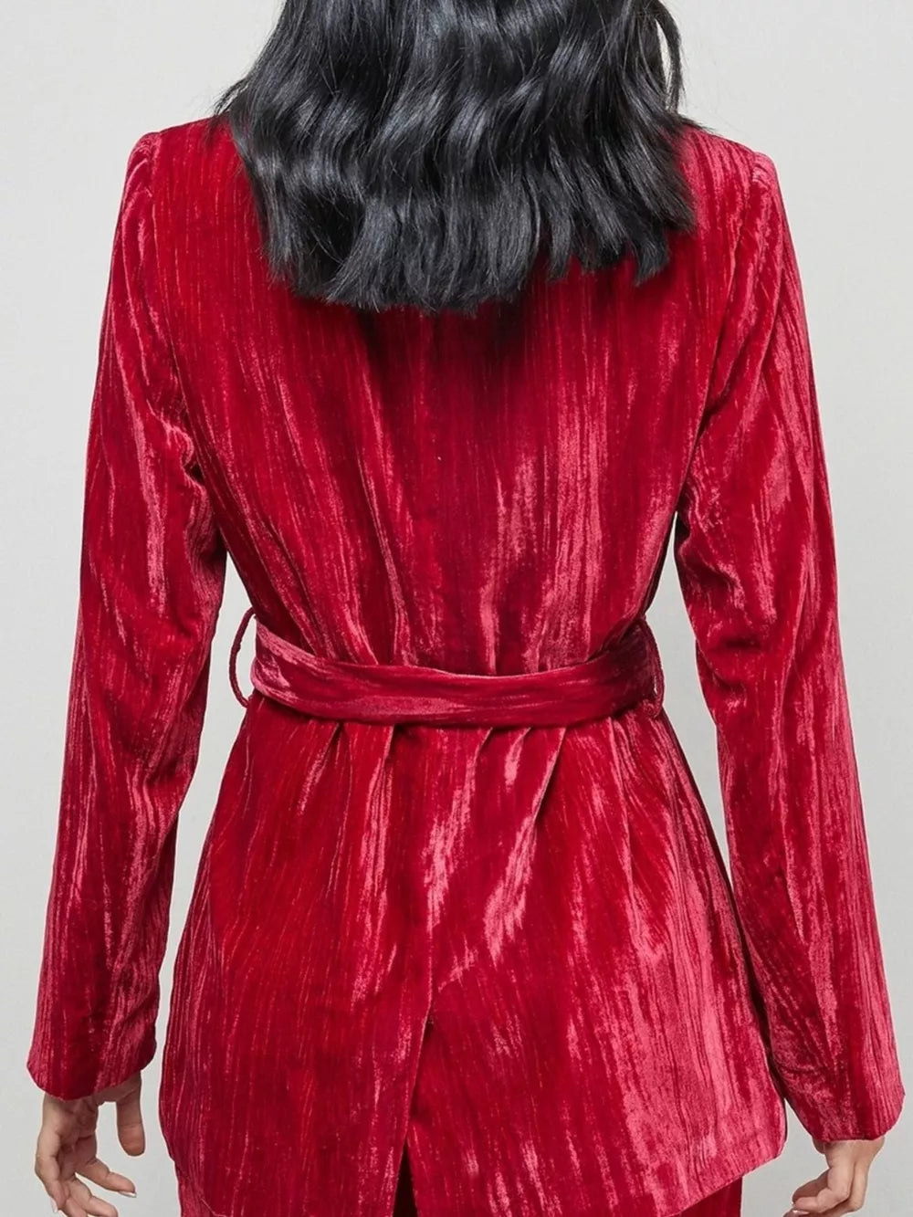 Burgundy velvet belted blazer with textured fabric detail.