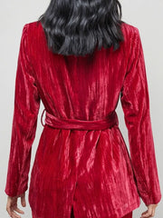 Burgundy velvet belted blazer with textured fabric detail.