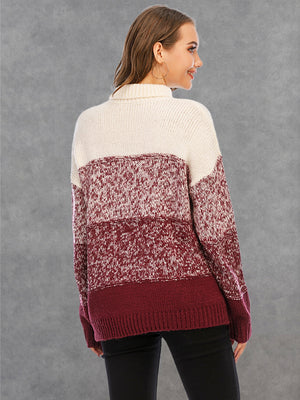 Colorblock knit turtleneck sweater in wine and cream with defined panels and a speckled pattern.