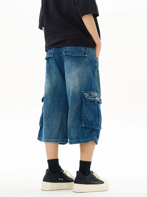 Relaxed fit denim cargo shorts in vintage blue with multiple pockets.