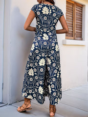 Botanical print culotte jumpsuit in navy with short sleeves and wide legs.