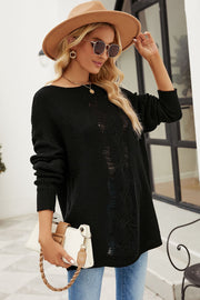 Black distressed knit sweater with boat neck and cable knit detail.