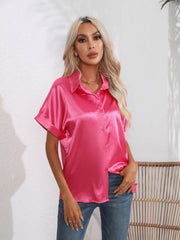 Hot pink satin boxy sleeve blouse with button-down front and cuffed sleeves.