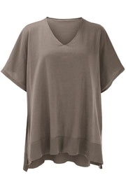 Relaxed V-neck knit poncho top in brown with short sleeves and ribbed hem.
