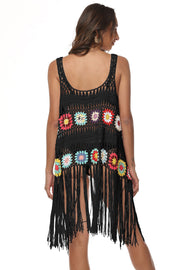 Black crochet vest with colorful floral squares and fringe detail, scoop neck, sleeveless.
