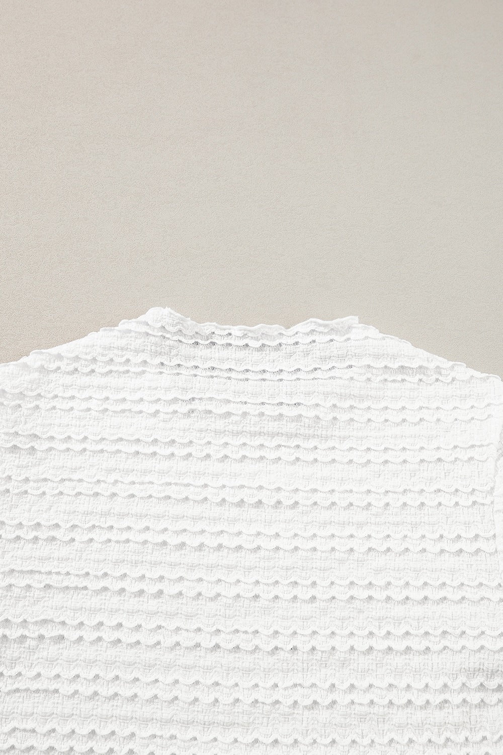 White textured long sleeve blouse with ruffle trim neckline