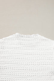 White textured long sleeve blouse with ruffle trim neckline