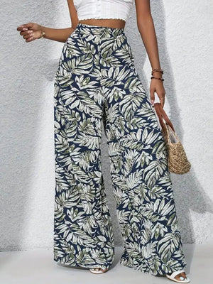 Palazzo trousers with tropical leaf print in navy, green, and white, 100% polyester.
