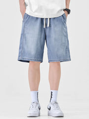 Light blue denim shorts for men with drawstring waist and loose fit.