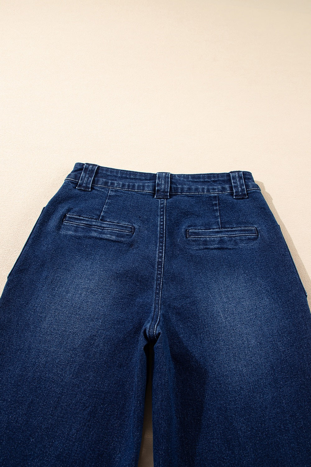 Mid-rise straight leg jeans in dark wash denim with two back pockets and belt loops.