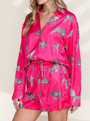 Hot pink silk pajama set with leopard print, long sleeves, button front, and drawstring shorts.