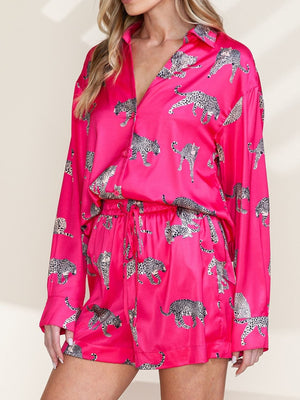 Hot pink silk pajama set with leopard print, long sleeves, button front, and drawstring shorts.