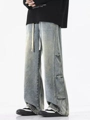 Oversized vintage wash wide leg jeans in light blue with distressed details and drawstring waist.