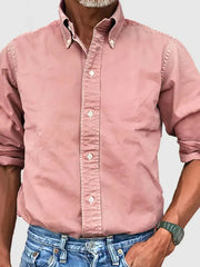 Blush pink Oxford button-down shirt with a relaxed fit and rolled sleeves.