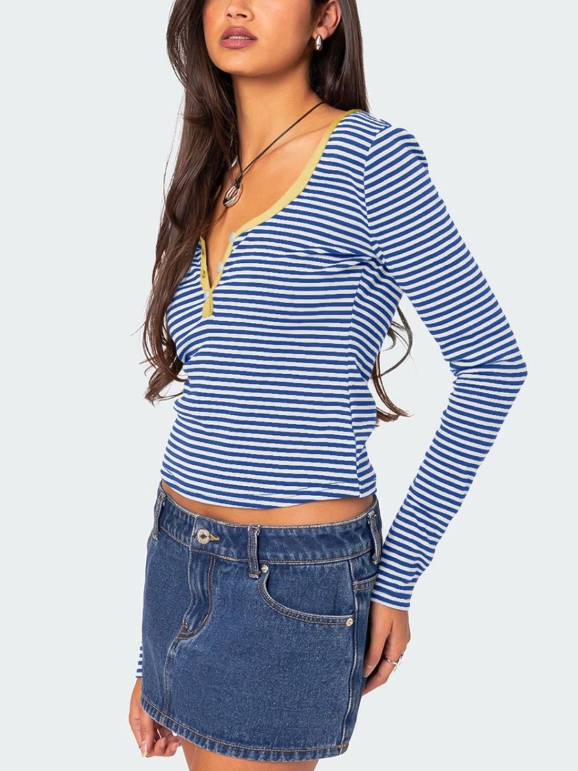 Blue and white striped long sleeve henley shirt with contrast yellow collar and button detail.