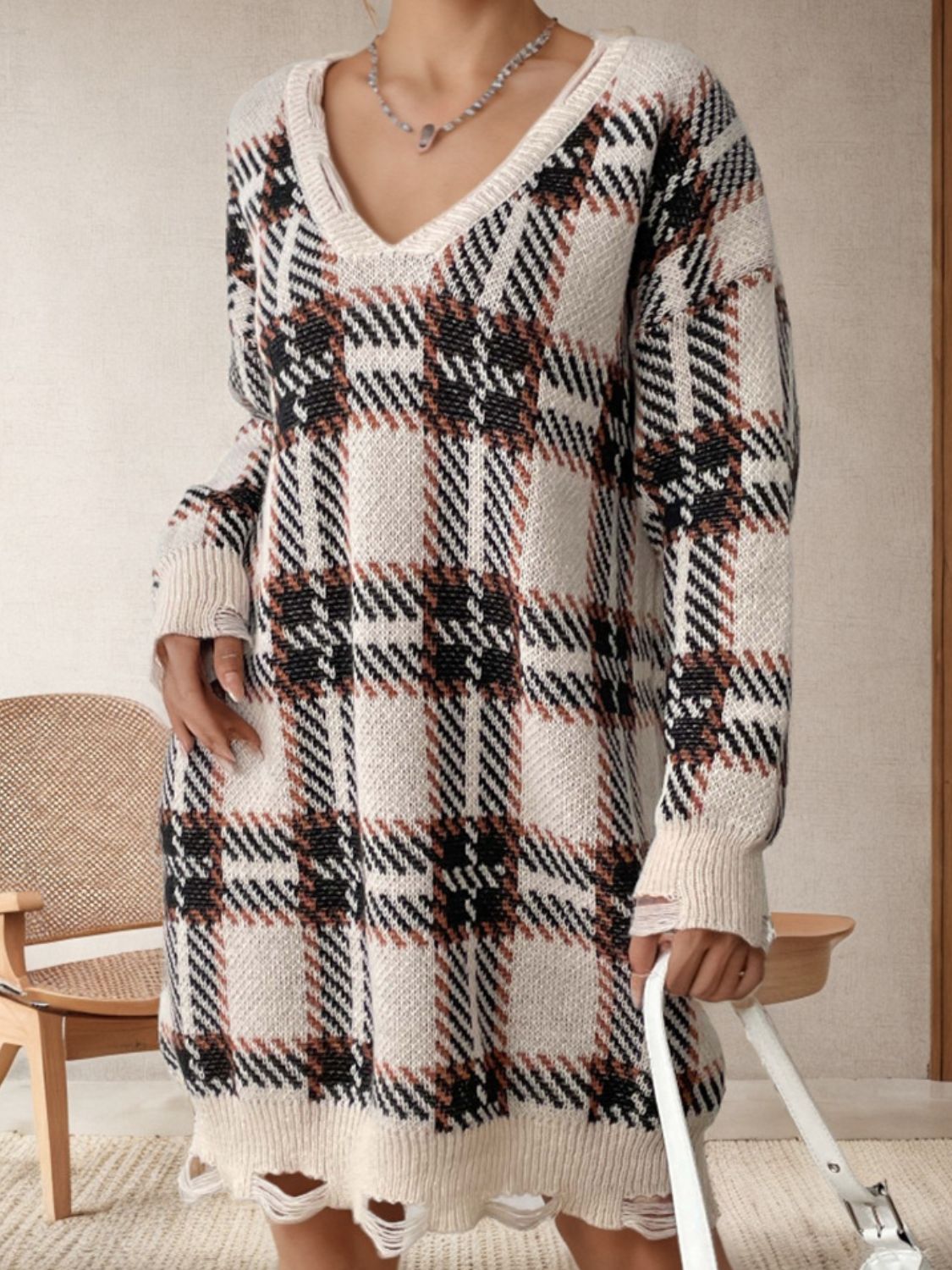 Plaid knit tunic with distressed hemline and V-neck.