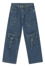 Medium wash denim cargo pants with buckle flap pockets and wide leg cut.