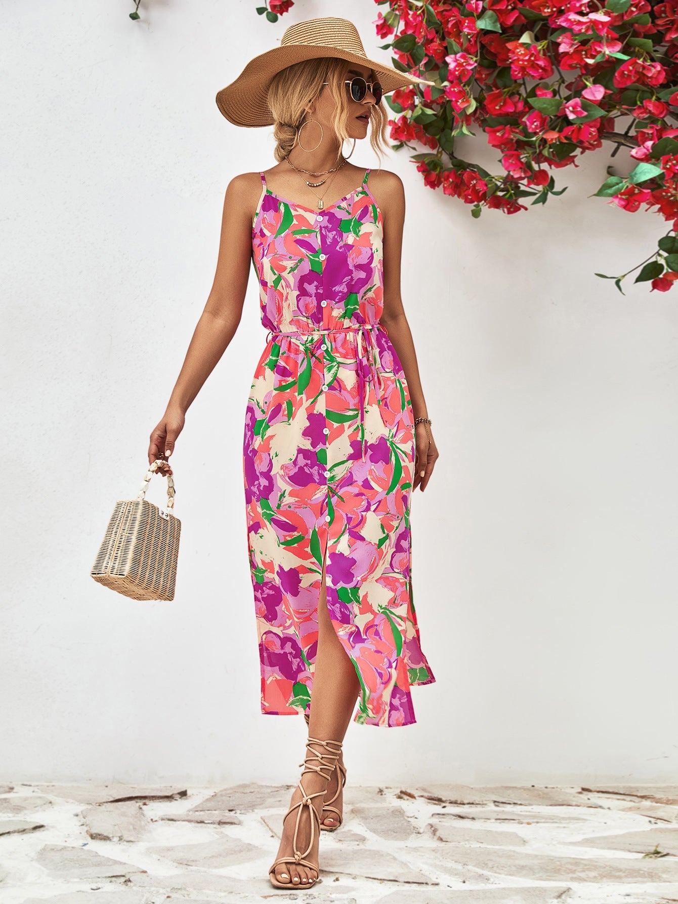 Floral print midi dress with spaghetti straps, button-down front, belted waist, and side slits in red-violet and orange hues.