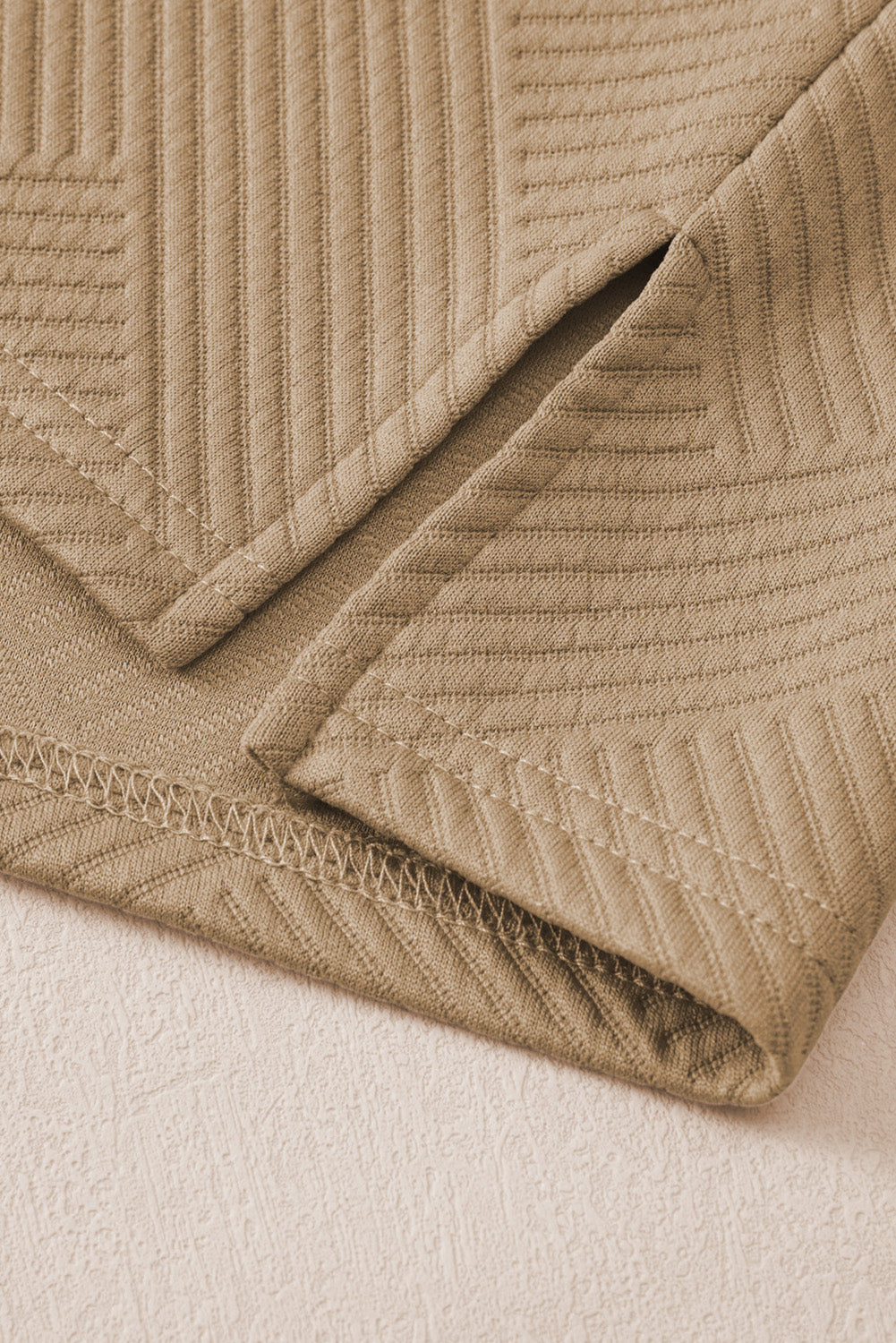 Tan textured polo set culottes with wide legs and subtle chevron pattern detail.